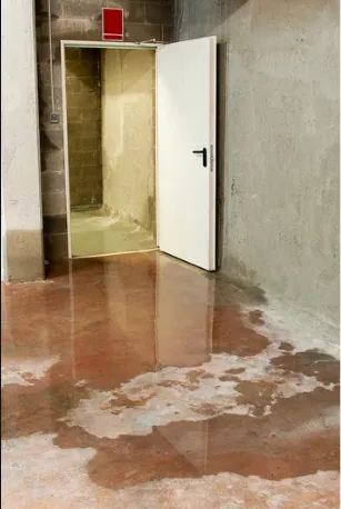Standing water covering the floor of a room after a flood
